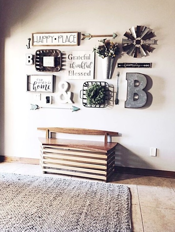 a lovely farmhouse gallery wall with signs in frames, a metal monogram, some potted blooms and metal elements