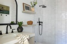 a mid-century modern bathroom with white stacked tiles, wooden beams, a ribbed vanity and black fixtures