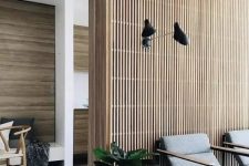 a mid-century modern interiors with plenty of stained wood incorporated – a wood slat accent wall and wood clad walls in other spaces
