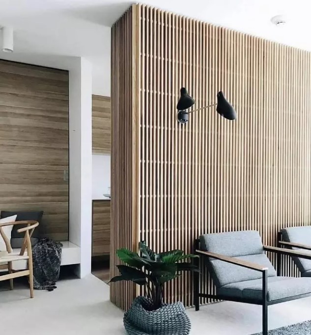a mid-century modern interiors with plenty of stained wood incorporated - a wood slat accent wall and wood clad walls in other spaces