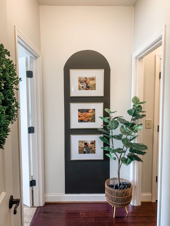 a mini gallery wall of family pics with a special accent with paint is a great solution for a modern entryway and not only