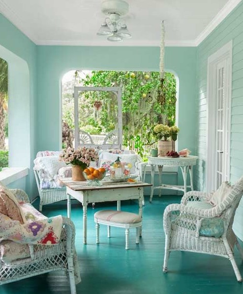a lovely sunroom with wicker furniture