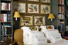 a moody vintage bedroom with grey walls and bookshelves, an upholstered bed with printed bedding, a gallery wall of vintage posters