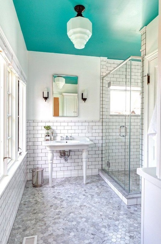 A white bathroom with a colourful ceiling