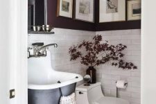 a refined moody mudroom with purple walls and white tiles, a black wall-mounted sink, a basket and some bulbs and lights