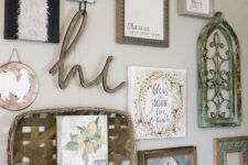 a rustic gallery wall with various artwork, a woven basket, a wooden calligraphy piece and some signs is a lovely idea for a farmhouse space