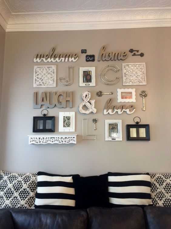 a small and cozy rustic gallery wall with words, an ampersand, some frames and vintage keys plus monograms