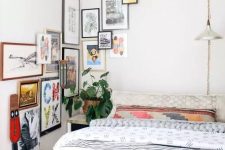 a small bedroom infused with color with printed textiles and a bold gallery wall that goes to the corner and next wall