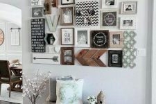 a stylish gallery wall with black and white family pics, wooden keys and signs, hearts and monograms is a lovely idea