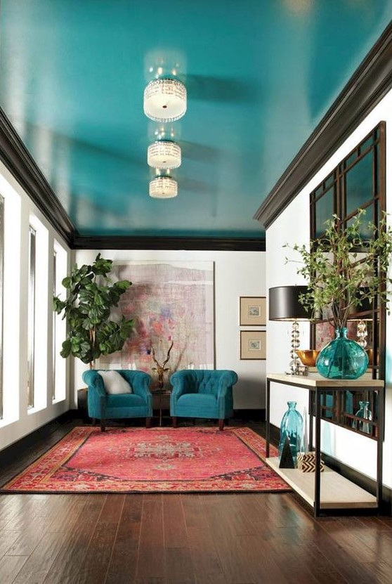 a super bright turquoise ceiling and matching chairs and accessories are a great color statement in the space