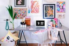 a super colorful gallery wall with mismatching frames and bold floral and abstract art will add a creative touch to the office