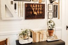 a vintage farmhouse gallery wall with pencils, maps, vintage photos, clocks, various artwork and little details looks amazing