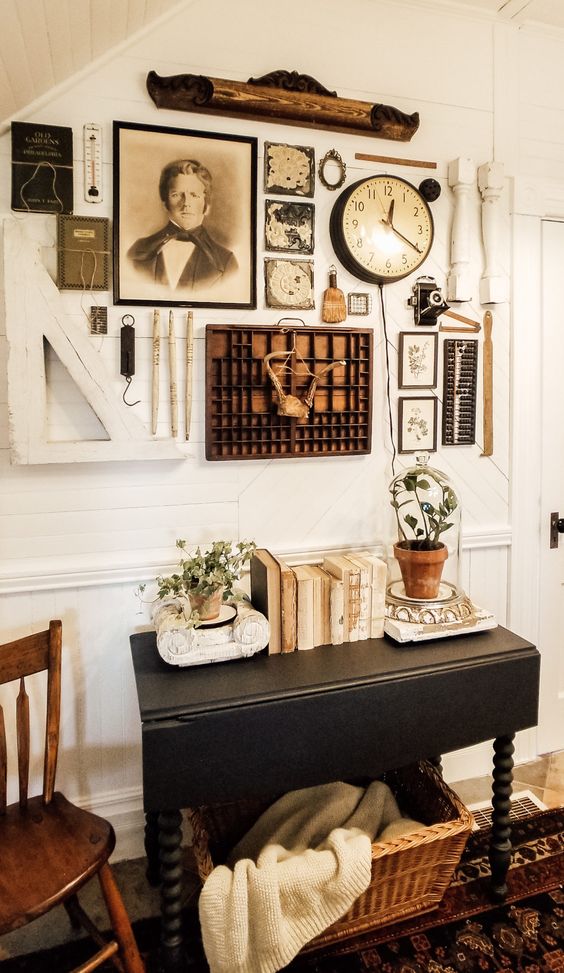 a vintage farmhouse gallery wall with pencils, maps, vintage photos, clocks, various artwork and little details looks amazing