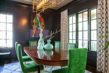 an extra bold dining room with a colorful wallpaper ceiling, a stained table, bold green chairs, printed textiles and artwork