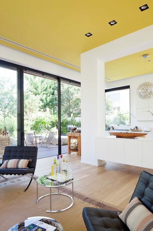 an unexpected sunny yellow ceiling creates a feeling of sunshine in the house everytime you look at it