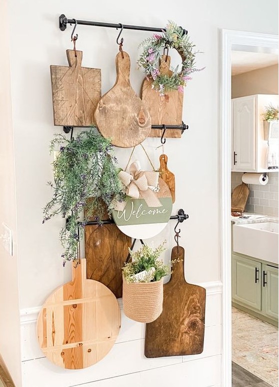 rustic kitchen wall decor with railings, cutting boards, greenery, potted and in a wreath is a lovely easy to realize idea