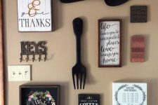 simple farmhouse wall decor with black cutlery, signs without frames, some calendars and other stuff is cool