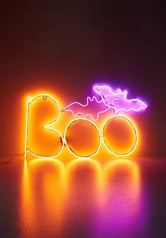a bold neon pink and yellow sign for Halloween decor is an amazing and very fresh idea to rock