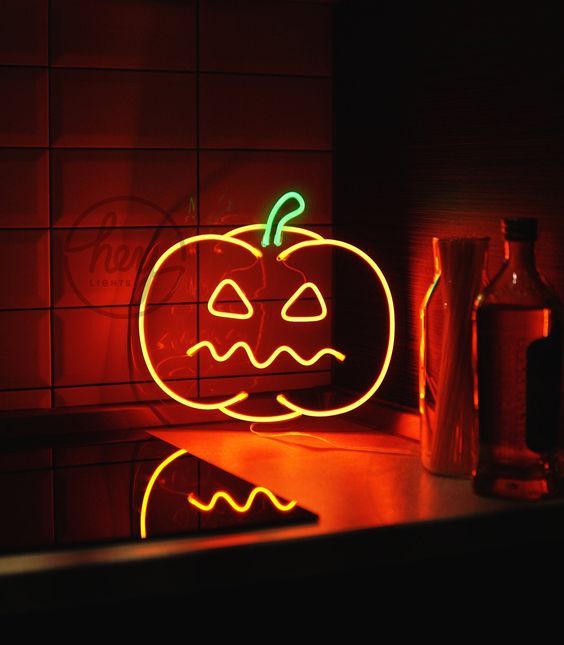 a spooky pumpkin neon sign is a great idea for Hallowene, it looks bold and super cool