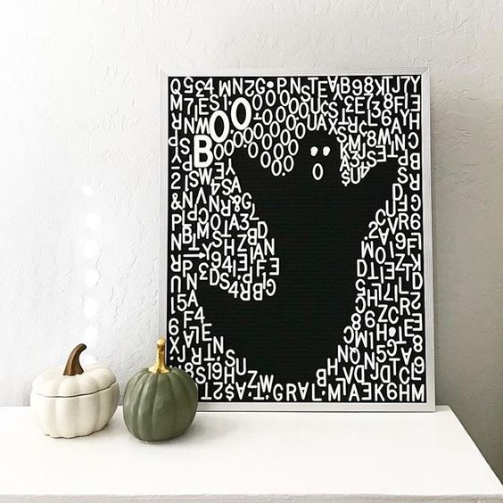 a gorgeous black and white letterboard sign showing a ghost with letters and numbers is a lovely idea for Halloween