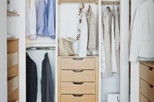 11 a small and cute closet with built-in shelves, drawers, built-in lights and a woven pouf plus racks for clothes