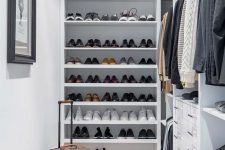 15 a small and stylish manly closet in white, with lots of open shoe shelves, holders with hangers, built-in drawers and lights