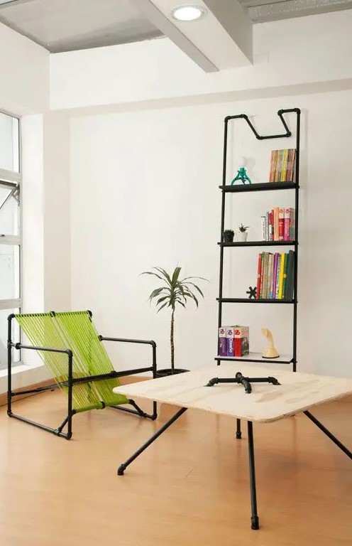 a bold modern nook with an exposed pipe shelving unit, a pipe and neon green twine chair, a coffee table or plywood and pipes is a cool space