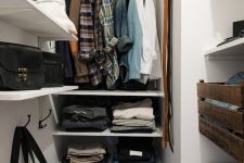 18 a small closet with wall-mounted and built-in shelves, a rack for hanging clothes, some crate drawers and boxes for shoes