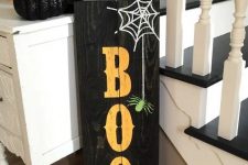 19 a black pallet sign with BOO letters, a web and a spider is easy to make yourself giving a rustic feel to Halloween decor