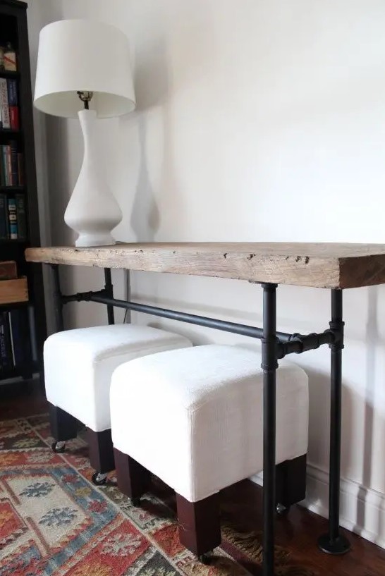 a chic industrial console table with piep legs and a wooden slab on top is a lovely idea for an entryway
