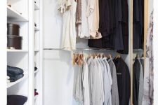 21 a small contemporary closet with holders for hangers, open shelves for various stuff, a basket and a large mirror