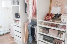23 a small glam closet with holders and hangers, built-in drawers, open shelving, artworks, a faux fur stool and a printed rug