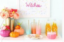 24 a colorful Halloween drink bar with bright pumpkins, ombre glasses and a sprinkle sign, a lush floral centerpiece