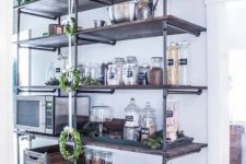 27 a large industrial shelving unit composed of exposed pipes and stained wood is a cool solution for an industrial or rustic pantry or kitchen