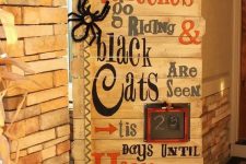 29 a gorgeous pallet sign with ribbons, a black and white banner, a faux spider and a frame is amazing for rustic Halloween decor