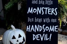 35 a modern black and white sign with a funny quote and a black and white pumpkin are perfect for outdoor Halloween decor