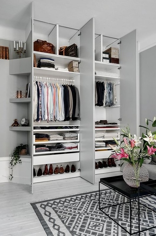a stylish small built-in closet with shelves up and down and some holders for clothes hangers is a perfect idea