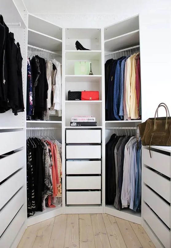a white hexagon-shaped closet with drawers and open shelves and a window is a lovely space to store clothes and shoes