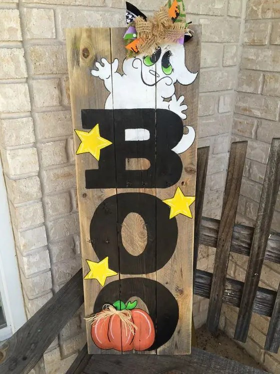 colorful BOO sign with yellow stars, a funky ghost, an orange pumpkin and some ribbon decor