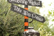 51 decorate any post in your backyard with a cool Halloween arrangment with several signs