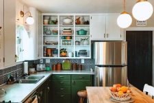 a 1950s farmhouse kitchen with white and green cabinets, a printed tile backsplash and a rug, a kitchen island with butcherblock countertops
