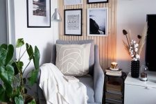 a Scandi reading nook with a grey chair with neutral textiles, a black and white gallery wall in the corner to add eye-catchiness