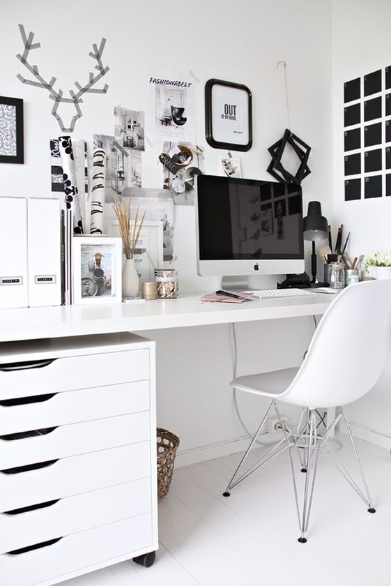 a Scandinavian home office done in mostly white, with a black noteboard and some more touches for an accent