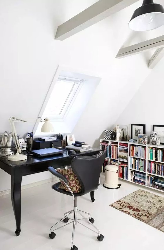 a Scandinavian home office with a bookshelf, a black vintage desk, a black chair, a table lamp, white wooden beams and black pendant lamp