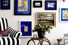 a bold gallery wall with black and white frames and electric blue mats for a more cohesive and a bit crazy look