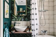 a catchy eclectic bathroom with white tiles, botanical wallpaper, a vanity with painted books and printed textiles