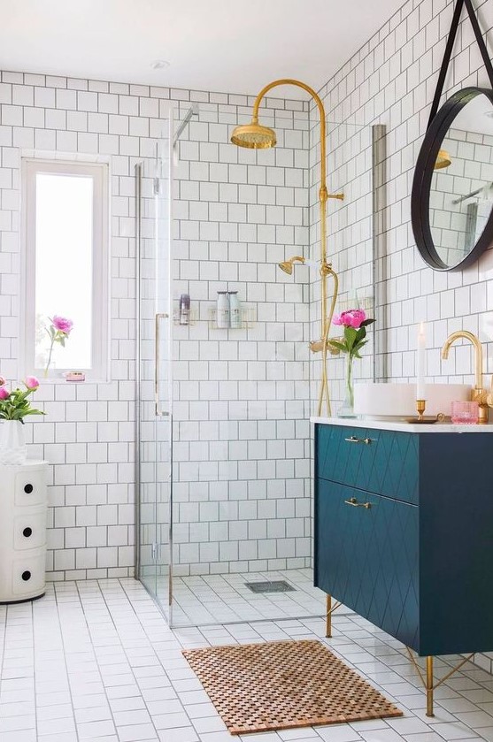 a chic bathroom with touches of glam and mid century modern decor, with gilded decor and a cork mat