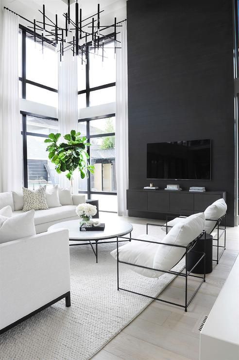 a lovely room with a black accent wall