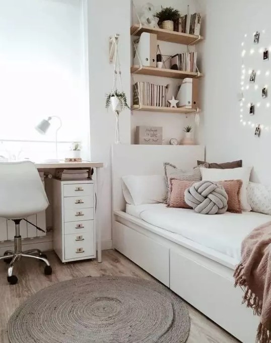 a chic neutral teen room with wall-mounted shelves, a comfy white bed with lots of pillows, a desk and a white chair plus potted plants