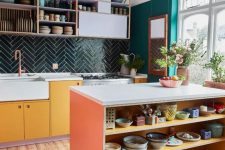 a colorful eclectic kitchen with emerald walls, a dark green chevron tile backsplash, bold cabinets and open shelves